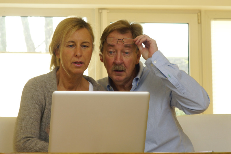 A couple looking for information together on a laptop